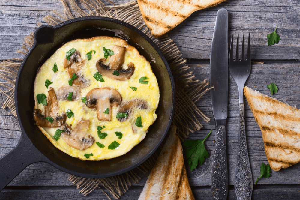 Baked omelette with mushrooms, served in a ceramic pan.