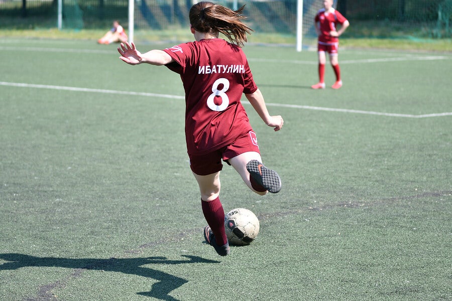 Woman playing a soccer match.